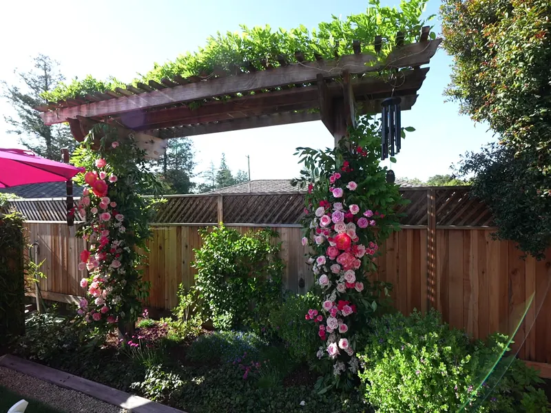 Tables set outdoors with linens and umbrellas for an afternoon event in Santa Clara