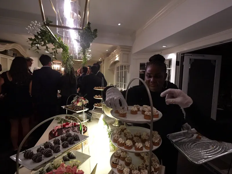 Server passing trays of appetizers to guests at a Cupertino reception
