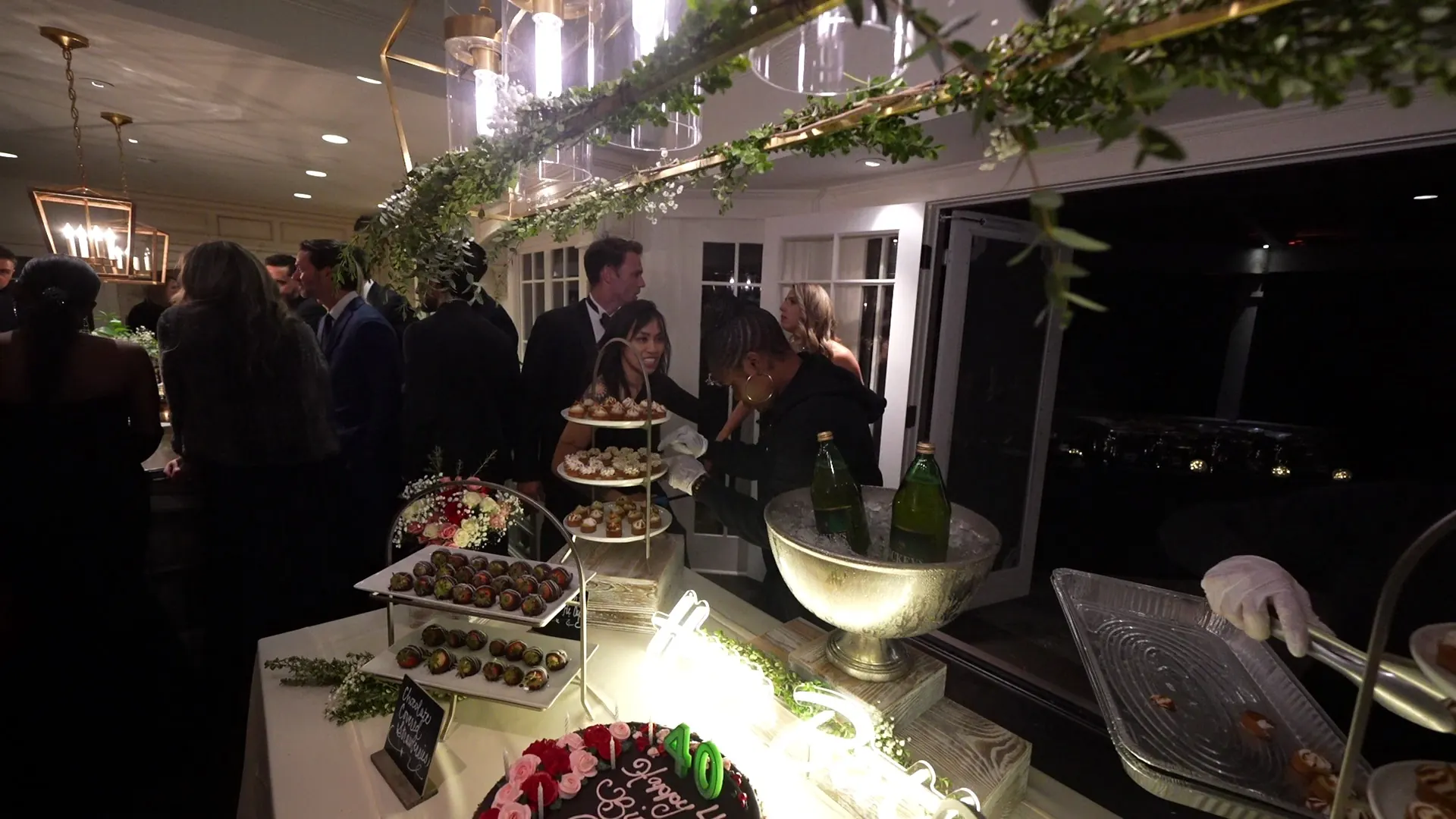 Server passing trays of appetizers to guests at a Campbell reception