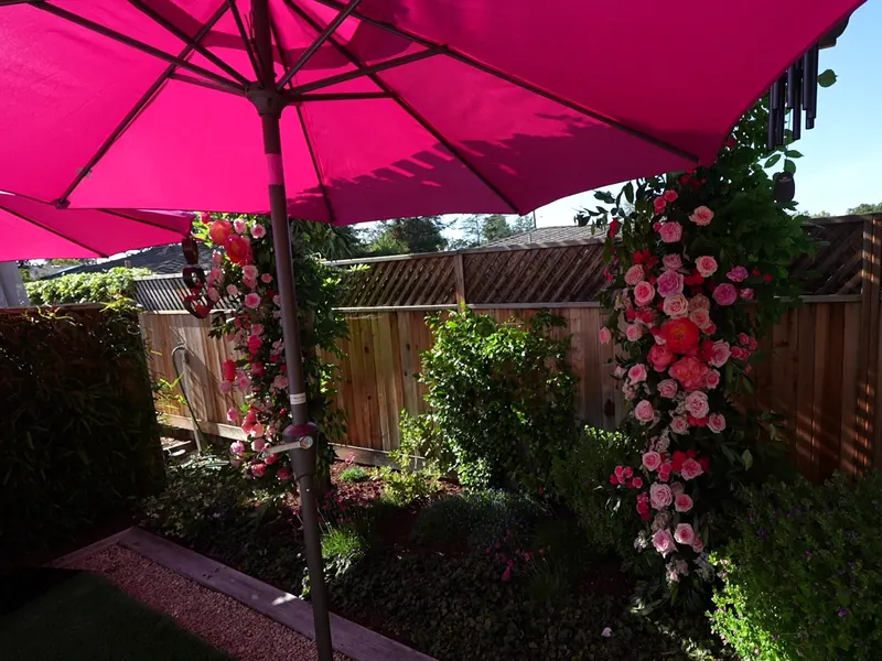 Tables set outdoors with linens and umbrellas for an afternoon event in Stanford