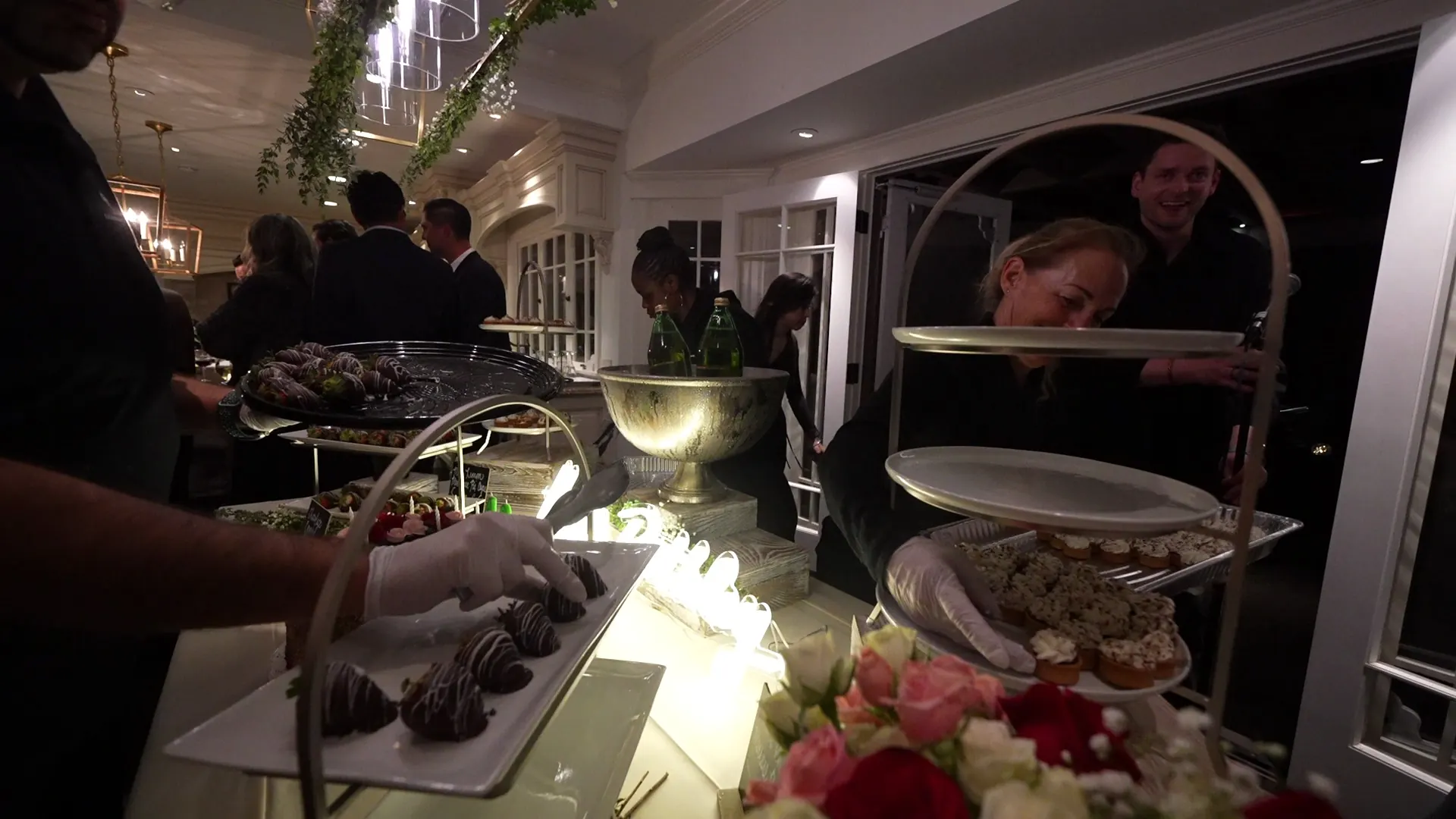 Server passing trays of appetizers to guests at a Mountain View reception
