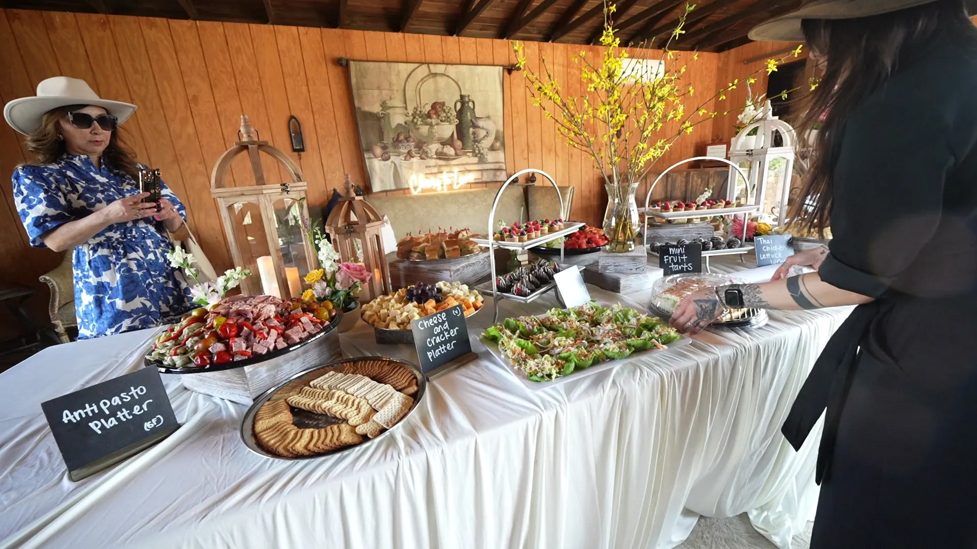 Tables set outdoors with linens and umbrellas for an afternoon event in San Jose