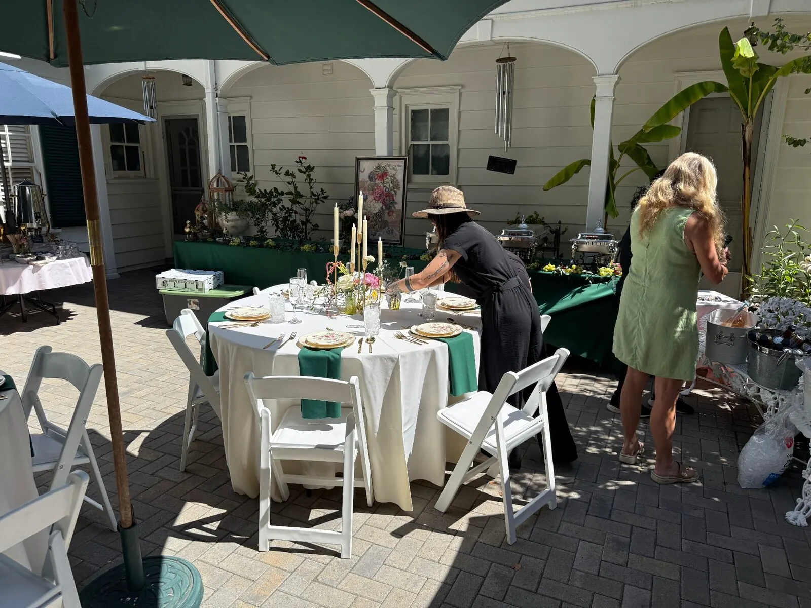Courtyard rounds finished in emerald cloths with upgraded rentals, stemware and complete settings — elevated tablescape rentals through our Sunnyvale catering service