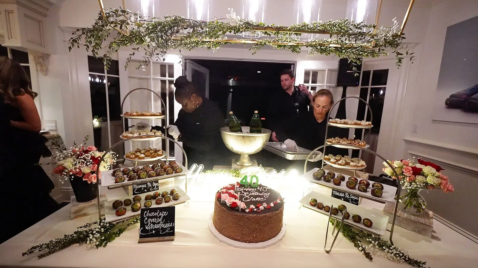 Dessert tablescape with chocolate-dipped strawberries, a celebration cake and tiered sweets over layered linens — dessert styling for Campbell catering celebrations