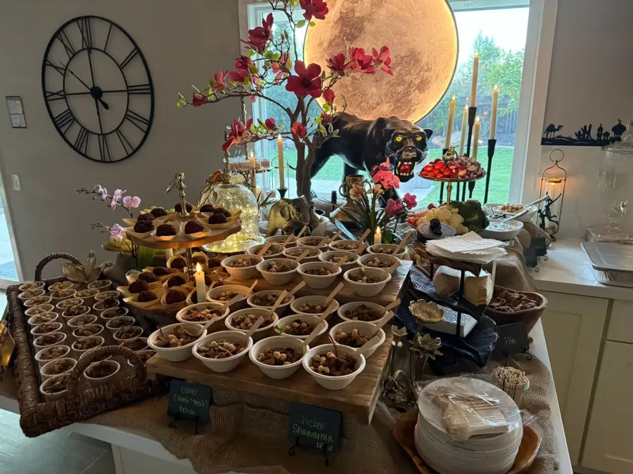 Mediterranean supper of shawarma chicken and döner kebob plated across a fully coordinated tablescape — dinner styling from our Mountain View catering florals team