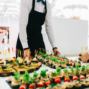 Waiters are serving delicious appetizers at a dinner party